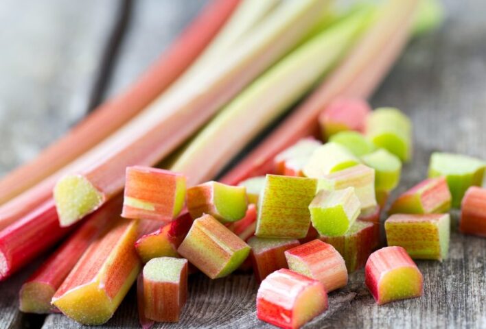 Pink rhubarb stems with some chopped pieces