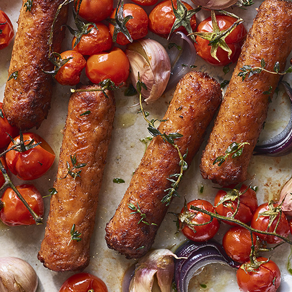 Linda McCartney product vegetarian sausages with cherry tomatoes garlic and herbs