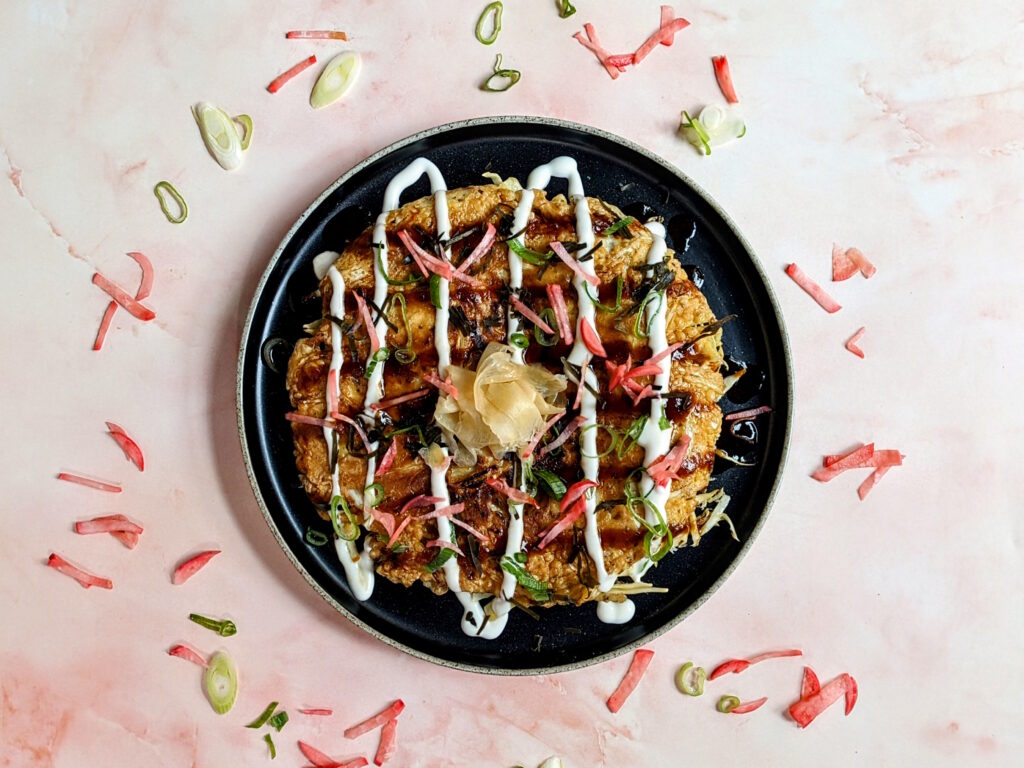 Traditional Okonomiyaki served with quick pickled radish, made on the Japanese Street Food class at COOK! in Manchester