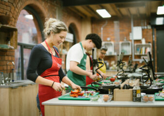 Person preparing vegetables in a hands-on Supper Club at COOK! with the Vegetarian Society