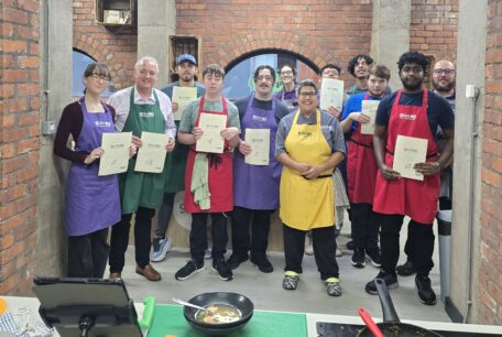 Students proudly display their certificates with tutor Maz